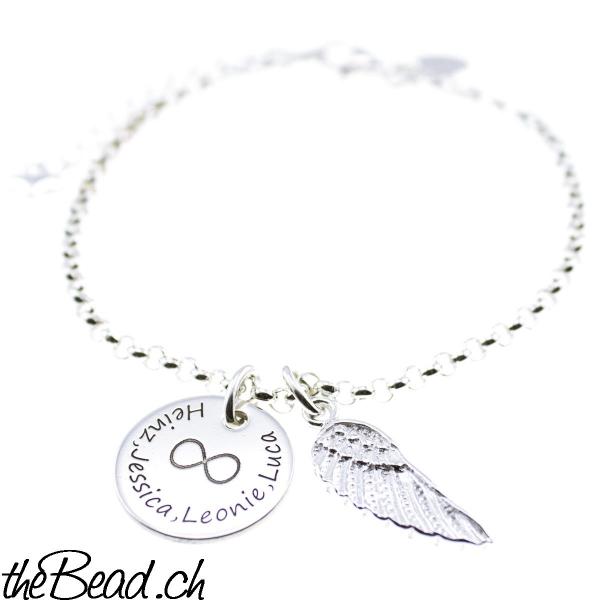 silver bracelet with wing pendant